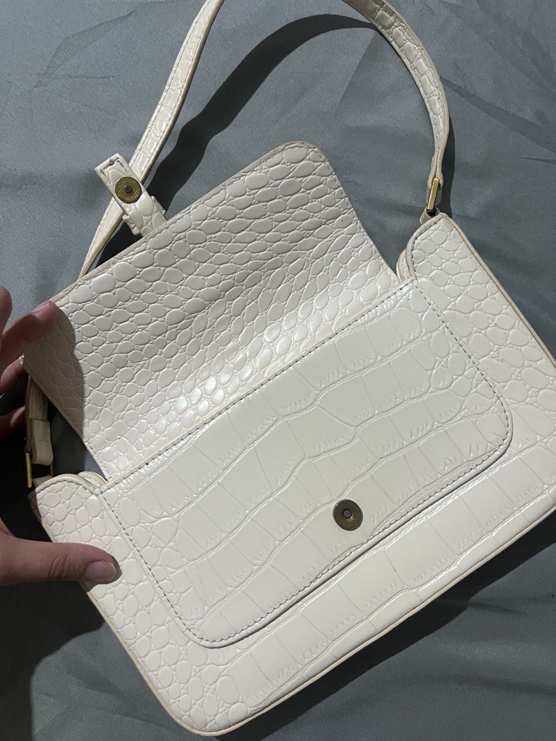 White Crocodile Pattern Shoulder Bag (Category: Shoulder Bags) located in Manila. Submitted by avelineco (Listing ID 1468516511, Image 3). Description: - Color: White - Material: Faux leather with embossed crocodile pattern - Closure: Flap with buckle accent and magnetic snap - Hardware: Gold-tone - Strap: Single matching shoulder strap - Usage: Great size for daily essentials or going out.