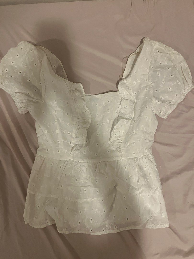 White eyelet ruffle crop top with puff sleeves (Category: Blouses) located in Manila. Submitted by vees.shop (Listing ID 1468683809, Image 1). Description: - Color: White with all-over floral eyelet embroidery - Material: Lightweight, breathable cotton - Neckline: Square neck with cute ruffle trim - Sleeves: Trendy puffed short sleeves - Fit: Stretchy smocked back panel for a snug fit - Style: Tiered peplum hem for a flattering shape - Ideal for: