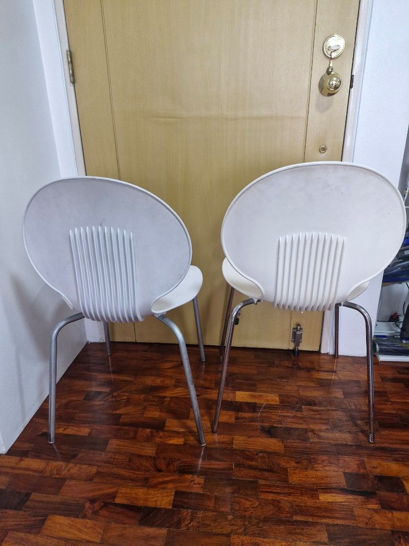 White modern chairs with metal legs (Category: Chairs) located in Quezon City. Submitted by acey18 (Listing ID 1468509928, Image 3). Description: - 2 modern white molded plastic chairs - Unique curved shape with stylish ribbed backrests - Sturdy metal legs - Stackable - Perfect for dining areas, study desks. - Condition: Minor scuffs and signs of wear on seats from daily use, but structurally solid They are similar but slightly differs in height.