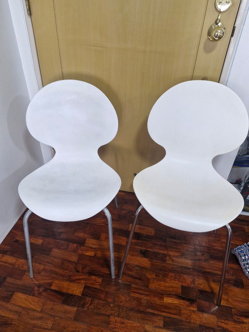 White modern chairs with metal legs (Category: Chairs) located in Quezon City. Submitted by acey18 (Listing ID 1468509928, Image 1). Description: - 2 modern white molded plastic chairs - Unique curved shape with stylish ribbed backrests - Sturdy metal legs - Stackable - Perfect for dining areas, study desks. - Condition: Minor scuffs and signs of wear on seats from daily use, but structurally solid They are similar but slightly differs in height.