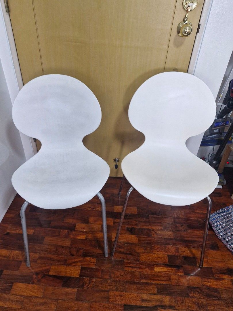 White modern chairs with metal legs (Category: Chairs) located in Quezon City. Submitted by acey18 (Listing ID 1468509928, Image 2). Description: - 2 modern white molded plastic chairs - Unique curved shape with stylish ribbed backrests - Sturdy metal legs - Stackable - Perfect for dining areas, study desks. - Condition: Minor scuffs and signs of wear on seats from daily use, but structurally solid They are similar but slightly differs in height.