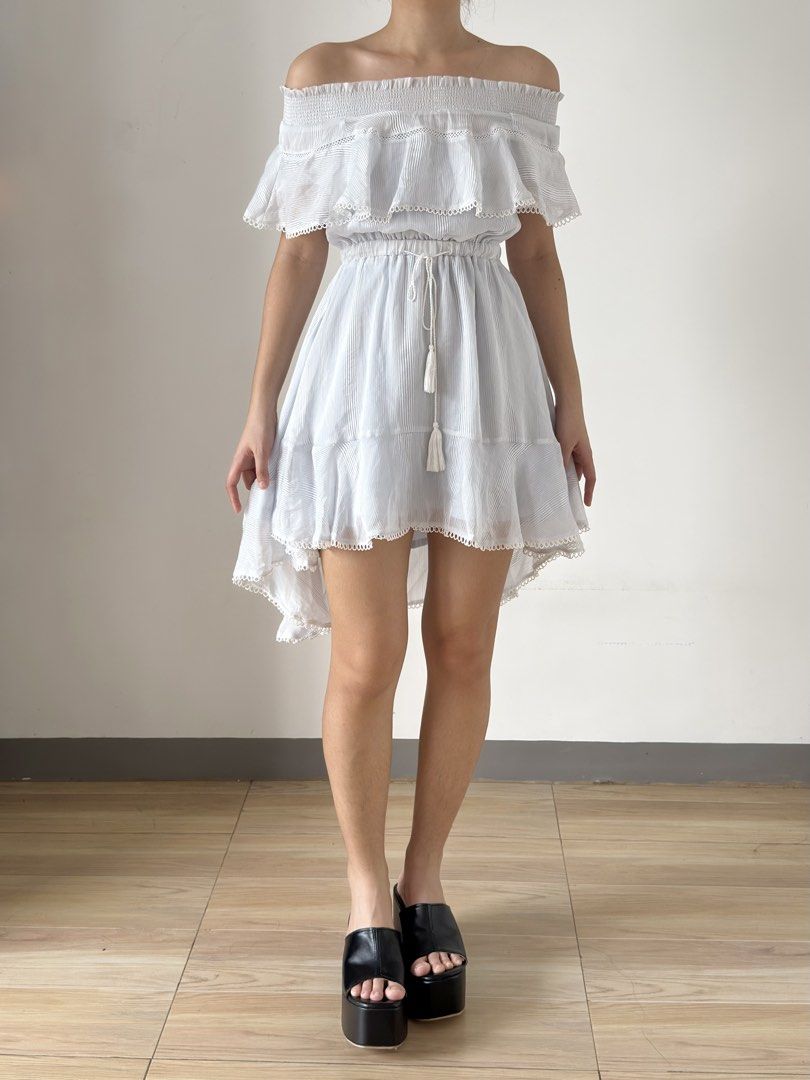 White Off-Shoulder Ruffle High-Low Dress with Drawstring (Category: Dresses) located in Las Pinas. Submitted by flyfarflower (Listing ID 1468514414, Image 2). Description: - Style: Off-shoulder mini dress with vertical pinstripes - Top: Layered ruffle overlay with elasticated ruched neckline - Waist: Adjustable drawstring waist with cute tassel ties - Hem: High-low hemline finished with delicate scalloped lace trim - Fit: Lightweight, breezy, and