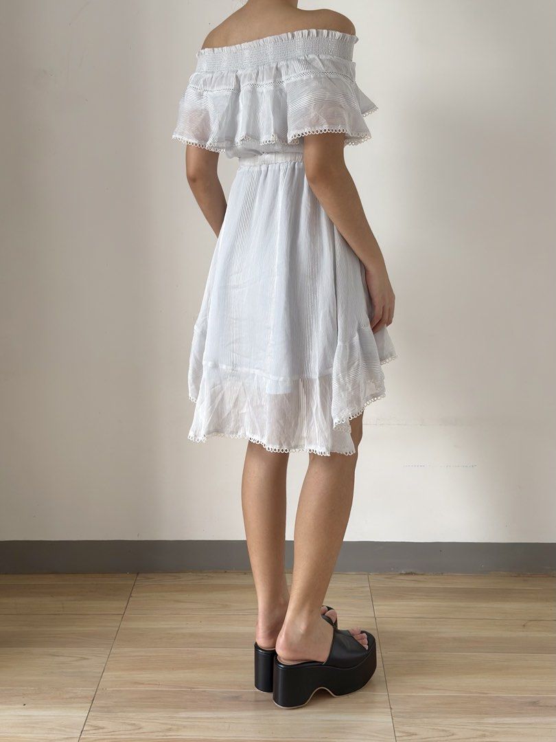White Off-Shoulder Ruffle High-Low Dress with Drawstring (Category: Dresses) located in Las Pinas. Submitted by flyfarflower (Listing ID 1468514414, Image 3). Description: - Style: Off-shoulder mini dress with vertical pinstripes - Top: Layered ruffle overlay with elasticated ruched neckline - Waist: Adjustable drawstring waist with cute tassel ties - Hem: High-low hemline finished with delicate scalloped lace trim - Fit: Lightweight, breezy, and