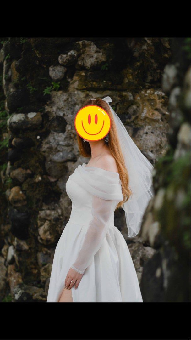 White Off-Shoulder Wedding Dress With slit from Vietnam (Category: Evening dresses & gowns) located in Daet. Submitted by ilovetakoyakiii (Listing ID 1468570103, Image 2). Description: - Color: White - Design: Off-shoulder draped style with sheer long sleeves - Skirt: Floor-length with a chic high leg slit - Condition: Worn once for an outdoor photoshoot Waits - 30 Bust - 36 Once lang nagamit. Quality yung tela nya makapal at medyo mabigat. May b
