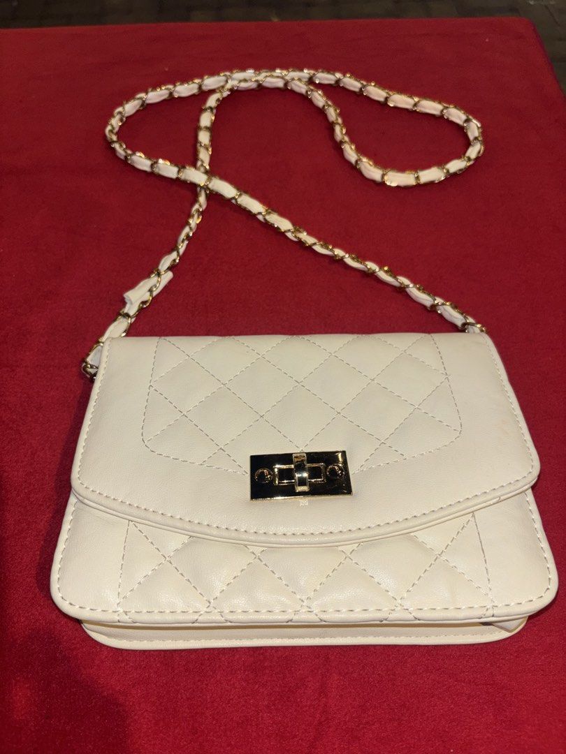 White Quilted Shoulder Bag with Gold Chain Strap (Category: Shoulder Bags) located in Manila. Submitted by jeromskito66462 (Listing ID 1468670695, Image 1). Description: - Color & Design: Elegant white quilted crossbody bag - Hardware: Gold chain strap woven with white material and gold twist-lock closure - Interior: Clean lining with a main compartment and zippered pocket under the flap - Size: Handy and compact, perfect for carrying your daily 