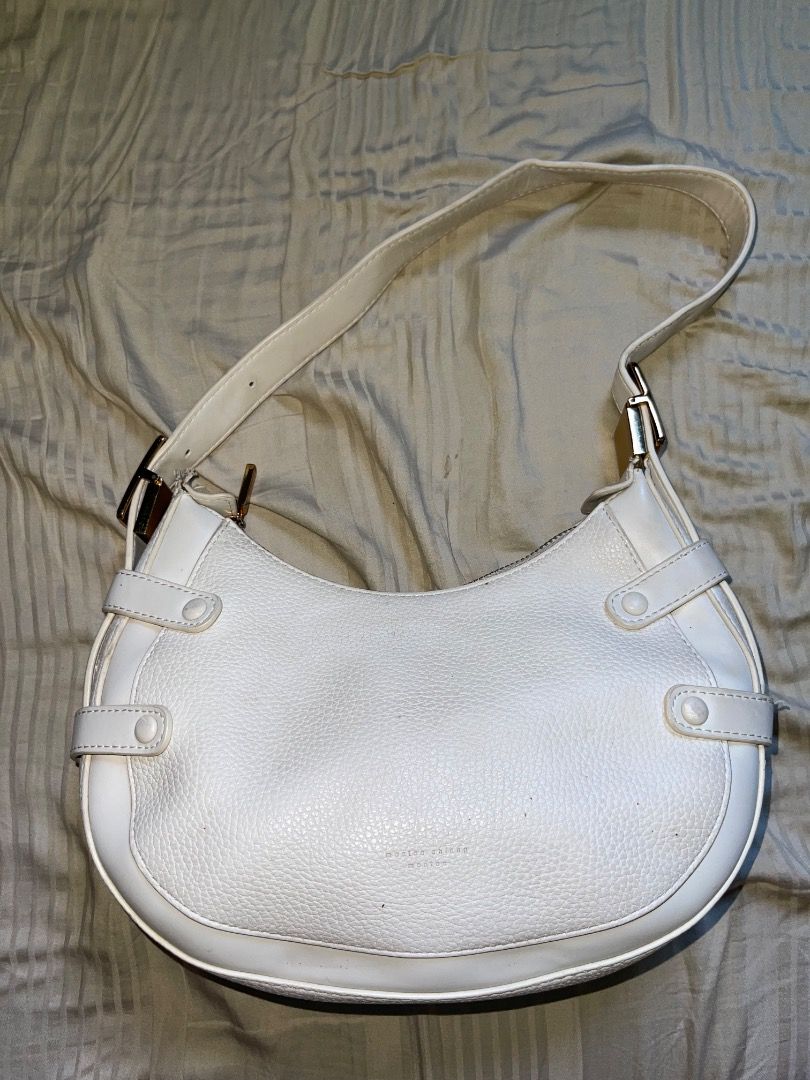White Shoulder Bag with Gold Hardware (Category: Shoulder Bags) located in Laoac. Submitted by pj_declutters (Listing ID 1468513934, Image 3). Description: - Material: Premium white pebbled leather - Hardware: Elegant gold-tone accents and zipper closure - Interior: Fabric lining with a convenient zippered pocket - Extras: Brand-new extra strap still wrapped in plastic inside - Design: Compact curved silhouette with modern front and side strap lo