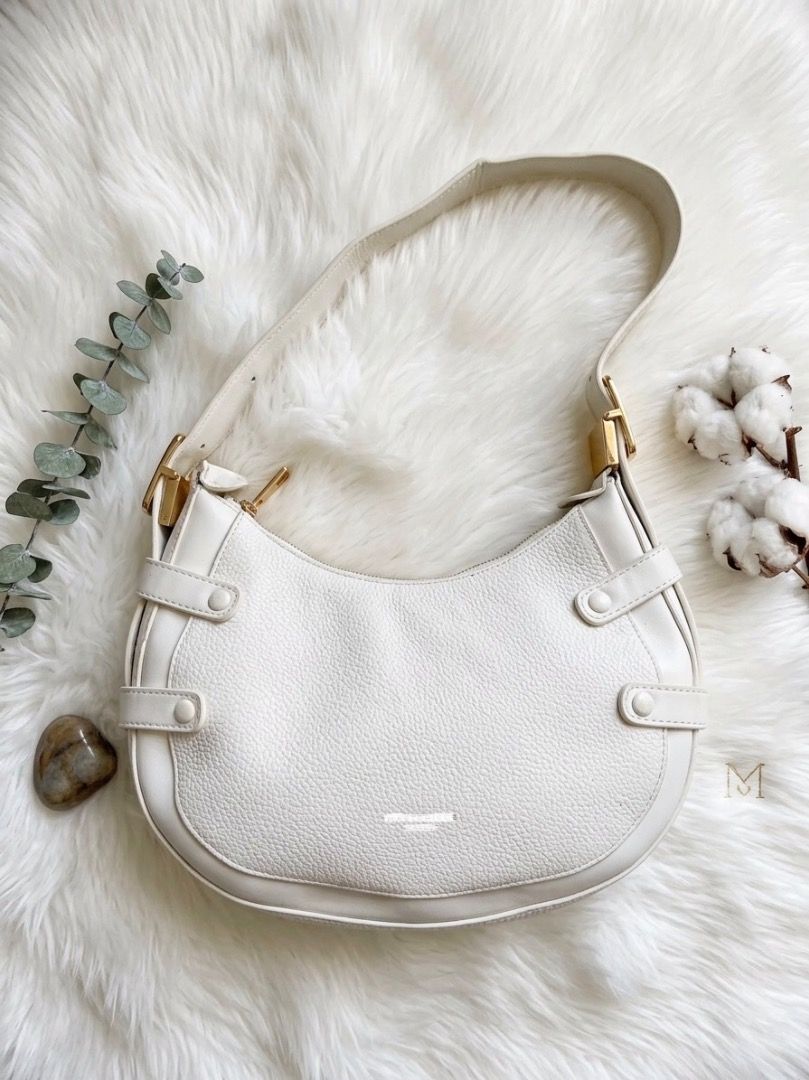White Shoulder Bag with Gold Hardware (Category: Shoulder Bags) located in Laoac. Submitted by pj_declutters (Listing ID 1468513934, Image 1). Description: - Material: Premium white pebbled leather - Hardware: Elegant gold-tone accents and zipper closure - Interior: Fabric lining with a convenient zippered pocket - Extras: Brand-new extra strap still wrapped in plastic inside - Design: Compact curved silhouette with modern front and side strap lo