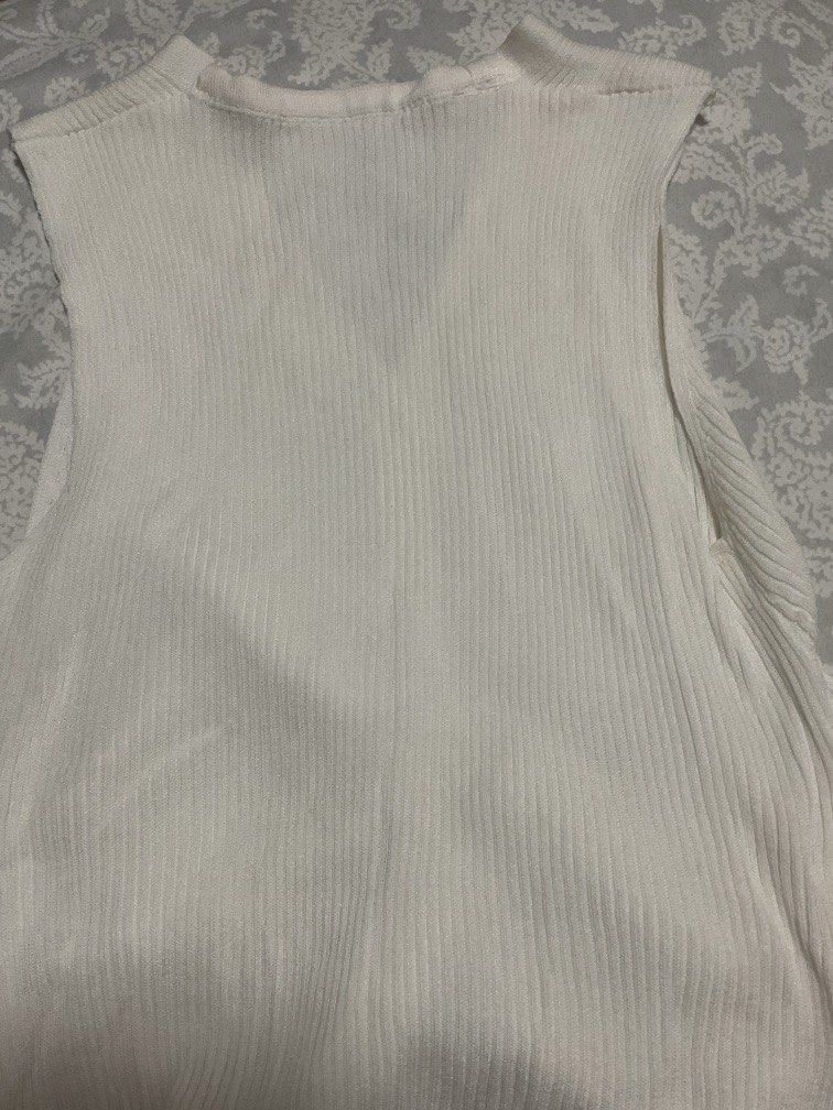 white sleeveless button-up knit (Category: Sleeveless) located in Pasig City. Submitted by 21thunder (Listing ID 1468670020, Image 2). Description: - tried on once - perfect for xs-s (around bustline 30-32 AA or A) - hugs the mid-waist nicely - not 100% opaque.