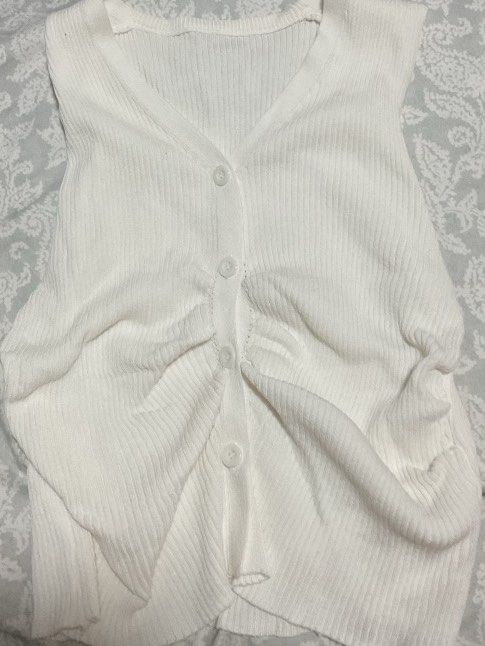 white sleeveless button-up knit (Category: Sleeveless) located in Pasig City. Submitted by 21thunder (Listing ID 1468670020, Image 1). Description: - tried on once - perfect for xs-s (around bustline 30-32 AA or A) - hugs the mid-waist nicely - not 100% opaque.