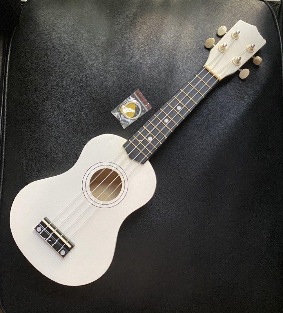 White Ukulele with pick, extra string and box (Category: Musical Instruments) located in Manila. Submitted by prelovedbymacybm (Listing ID 1468574926, Image 1). Description: RFS: Decluttering Issues: Minor scratch Mode of Payment: Gcash/Maribank .