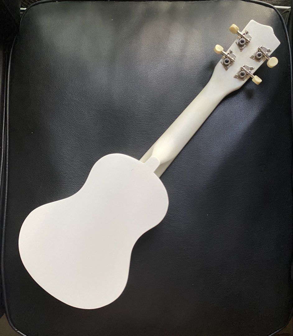 White Ukulele with pick, extra string and box (Category: Musical Instruments) located in Manila. Submitted by prelovedbymacybm (Listing ID 1468574926, Image 2). Description: RFS: Decluttering Issues: Minor scratch Mode of Payment: Gcash/Maribank .