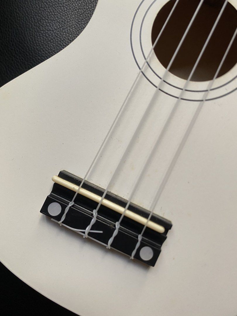 White Ukulele with pick, extra string and box (Category: Musical Instruments) located in Manila. Submitted by prelovedbymacybm (Listing ID 1468574926, Image 3). Description: RFS: Decluttering Issues: Minor scratch Mode of Payment: Gcash/Maribank .