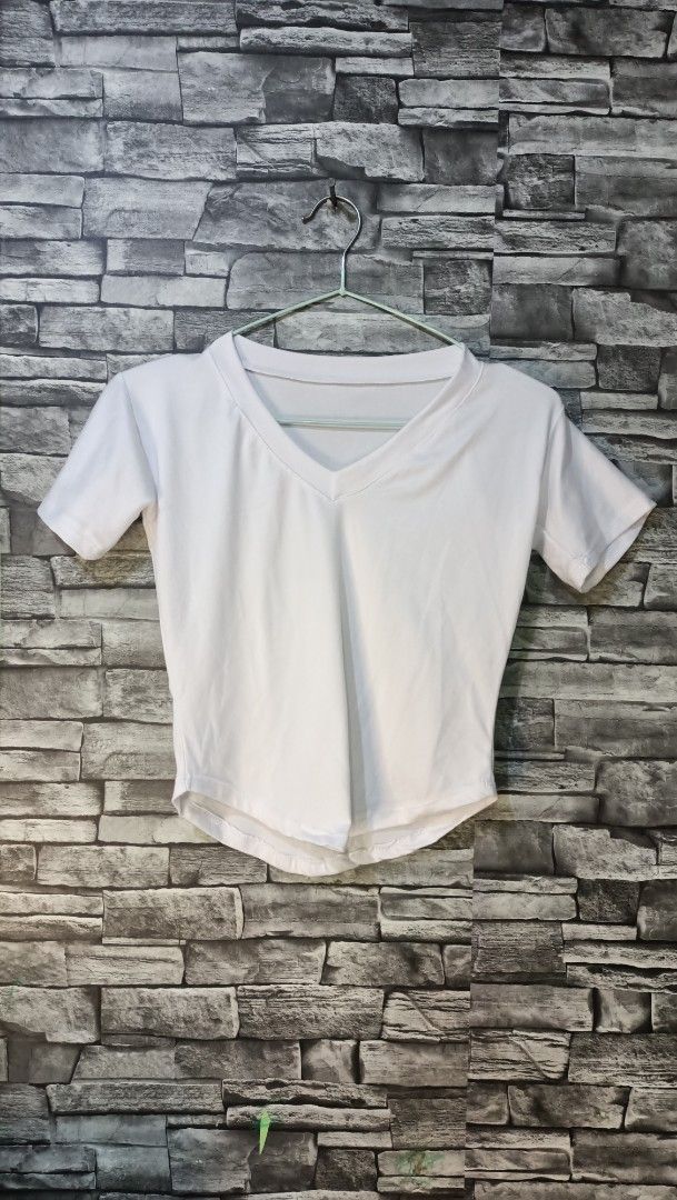 White V-neck short sleeve crop top (Category: Shirts) located in Antipolo. Submitted by reahespiritu (Listing ID 1468644979, Image 1). Description: - Color: White - Style: Short sleeve V-neck crop top - Fit: Stretchy and soft, cropped length with a curved hem - Versatility: Easy to pair with high-waisted jeans or skirts - Condition: Clean, well-maintained.