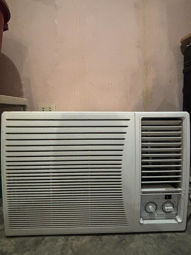 Window Air Conditioner Unit with Dual Control Knobs (Category: Air Conditioning and Heating) located in Manila. Submitted by swiftstar_7ecd18 (Listing ID 1468512499, Image 1). Description: - Type: Standard window air conditioner - Color: Solid white plastic housing - Controls: Dual rotary knobs and toggle switch for temperature and fan speed adjustment - Airflow: Horizontal ventilation slats with adjustable vertical louvers on the right - Conditi