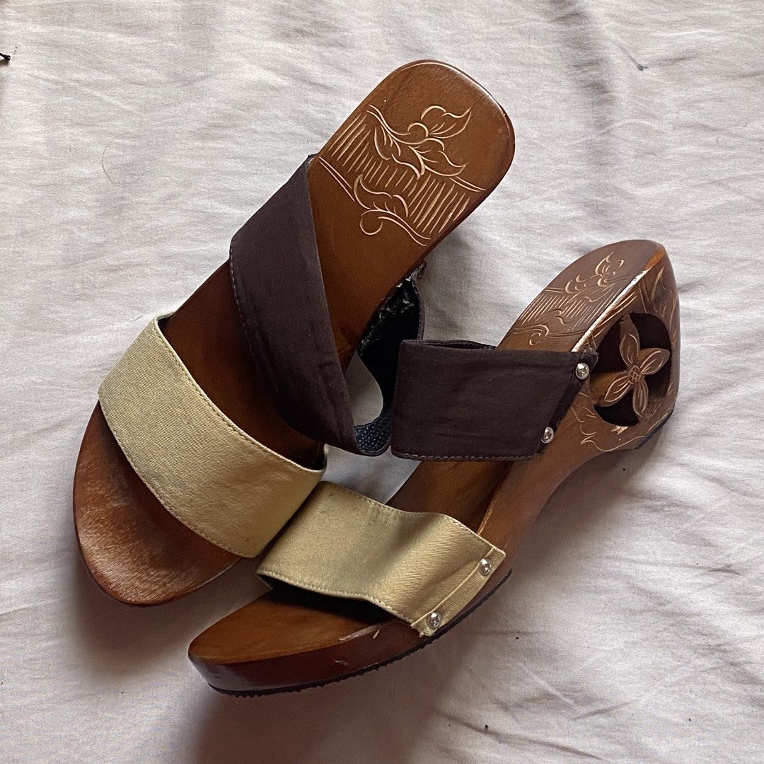 Wooden wedge sandals (Category: Wedges) located in Manila. Submitted by nendi.isma (Listing ID 1468685038, Image 2). Description: -Never used, rfs: got the wrong size -from ₱611 to ₱549 lp - Style: Slip-on wooden wedge heels - Straps: Two-tone fabric (gold front strap, brown top strap) - Heel Design: Stylish cutout flower carved into the side - Footbed: Charming floral engraving etched into the surface - Comfort: Easy to walk in with a comfortabl