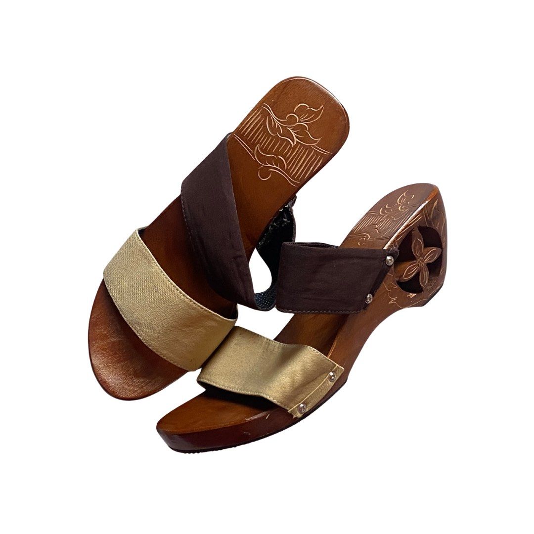 Wooden wedge sandals (Category: Wedges) located in Manila. Submitted by nendi.isma (Listing ID 1468685038, Image 1). Description: -Never used, rfs: got the wrong size -from ₱611 to ₱549 lp - Style: Slip-on wooden wedge heels - Straps: Two-tone fabric (gold front strap, brown top strap) - Heel Design: Stylish cutout flower carved into the side - Footbed: Charming floral engraving etched into the surface - Comfort: Easy to walk in with a comfortabl