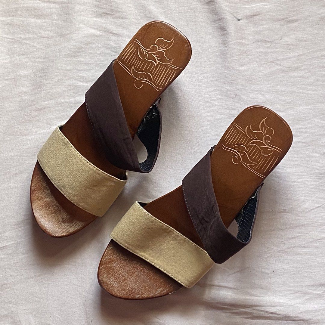 Wooden wedge sandals (Category: Wedges) located in Manila. Submitted by nendi.isma (Listing ID 1468685038, Image 3). Description: -Never used, rfs: got the wrong size -from ₱611 to ₱549 lp - Style: Slip-on wooden wedge heels - Straps: Two-tone fabric (gold front strap, brown top strap) - Heel Design: Stylish cutout flower carved into the side - Footbed: Charming floral engraving etched into the surface - Comfort: Easy to walk in with a comfortabl