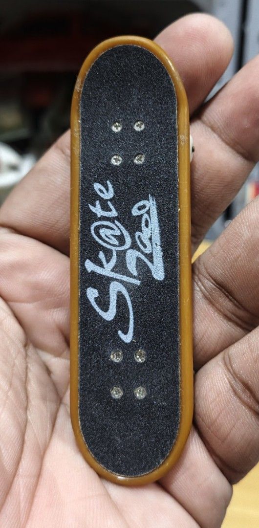 World Peace Fingerboard Mini Skateboard (Category: Skates, Rollerblades & Scooters) located in San Pedro. Submitted by toydibz (Listing ID 1468538375, Image 1). Description: - Type: Standard tech deck style fingerboard - Bottom Design: World Peace graphic with blue stars and a pink peace sign - Top Grip: Black grip tape featuring white 'Sk@te' and barcode print - Hardware: White wheels and metal trucks attached - Use: Fun little toy perfect for y