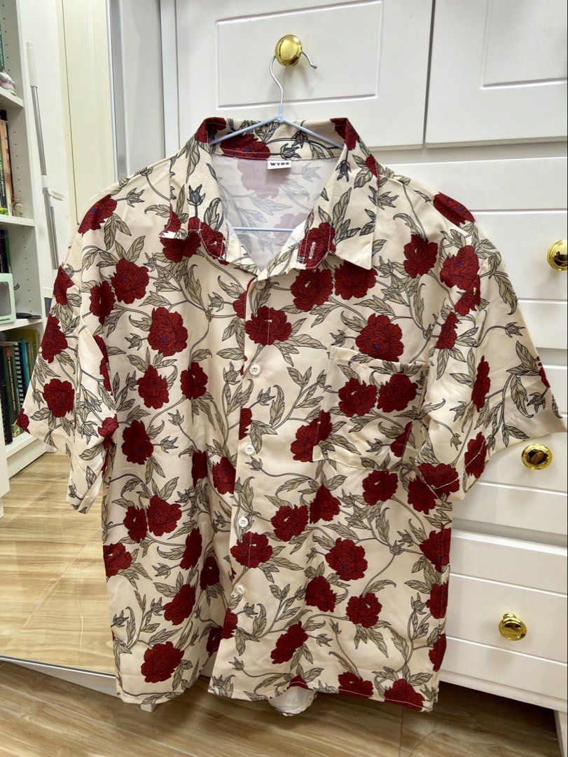 WYRS Floral Button Down Shirt Cream Red (Category: Blouses) located in Manila. Submitted by chi.declutter (Listing ID 1468528019, Image 1). Description: - Brand: WYRS - Color/Design: Cream with all-over red floral print - Material: Smooth satin-like fabric - Features: Short sleeves, classic collar, single left chest pocket, white front button closure - Style: Perfect for summer vacation and casual outings Free delivery for those who will avail 5 