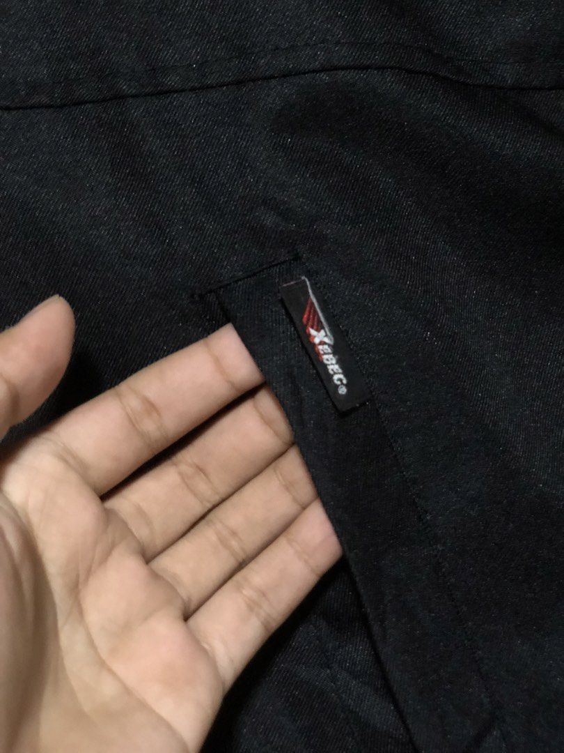 Xebec Bridgestone Racing Jacket Black (Category: Coats, Jackets and Outerwear) located in Calbayog City. Submitted by thriftme.bro (Listing ID 1468610702, Image 3). Description: - Color: Black with striking red and white shoulder stripes - Branding: Bridgestone logos on the chest and sleeve, plus Xebec logo tags - Design: High collar, full zip closure, and red-trimmed chest pocket zipper - Material: Thick, heavy-duty fabric - Functionality: Equip