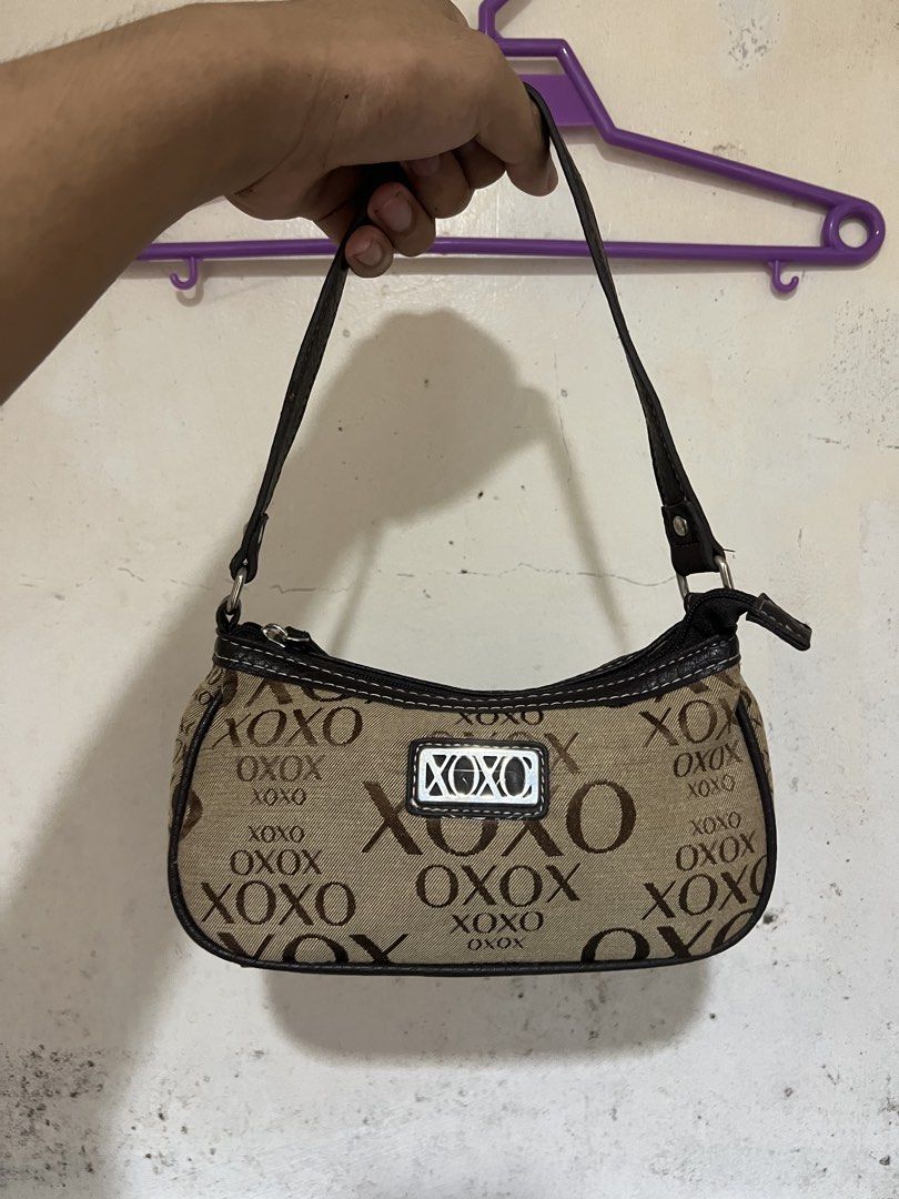 XOXO Accessories Monogram Shoulder Bag (Category: Shoulder Bags) located in Alburquerque. Submitted by ukaydecebuofficial (Listing ID 1468564518, Image 2). Description: - Brand: XOXO - Design: Brown and beige monogram print with faux leather trim and white contrast stitching - Hardware: Silver-tone with front metal logo plate - Closure: Secure zip top - Interior: Clean with fabric care tags intact - Size: Compact, perfect for everyday essentials.