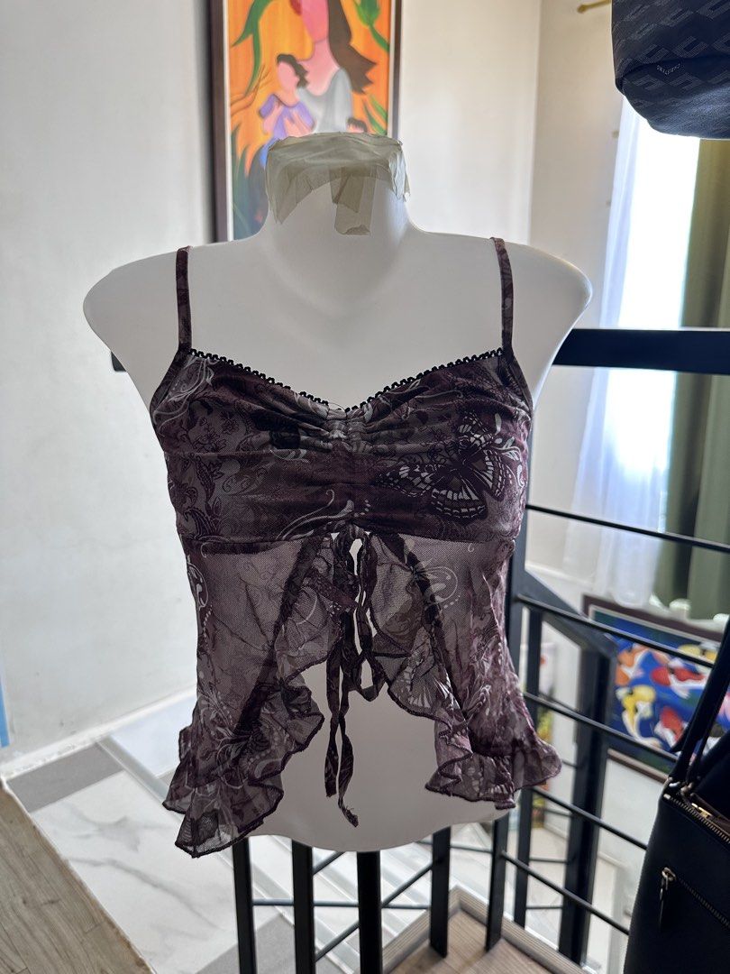 Y2K Butterfly Mesh Tie-Front Cami Top (Category: Sleeveless) located in Manila. Submitted by rachael_23 (Listing ID 1468527266, Image 1). Description: - Sheer mesh cami top with purple butterfly and floral print - Features delicate lace trim and a flattering ruched bust - Adjustable front ties with a cute ruffled hem - Stretchy, super lightweight, and great for layering - Perfect Y2K / coquette style piece - Ships fast from PH! Send a message for