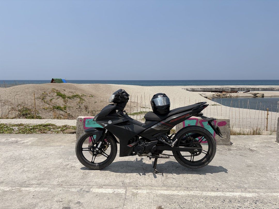 Yamaha Sniper 150 Motorcycle (Category: Motorbikes for Sale) located in Marikina City. Submitted by pong15 (Listing ID 1468592725, Image 2). Description: Yamaha Sniper 150 underbone motorcycle in matte black. Manual transmission with standard foot controls and center stand. Comes paired with matching black alloy wheels and disc brakes front and rear. Handlebar mirrors equipped on both sides. Body panels clean with red accents near the rear tail s