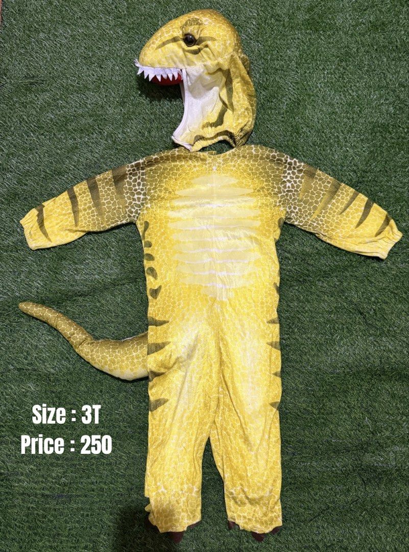 Yellow Dinosaur Costume Size 3T (Category: Babies & Kids Fashion) located in San Fernando. Submitted by InvisibleMe (Listing ID 1468709002, Image 1). Description: - Yellow dinosaur jumpsuit with fun long tail - Detailed scale pattern printed all over - Soft hood featuring teeth and open mouth design - Size: Fits toddlers around 3T - Condition: Clean, excellent, and ready to wear for Halloween or parties.