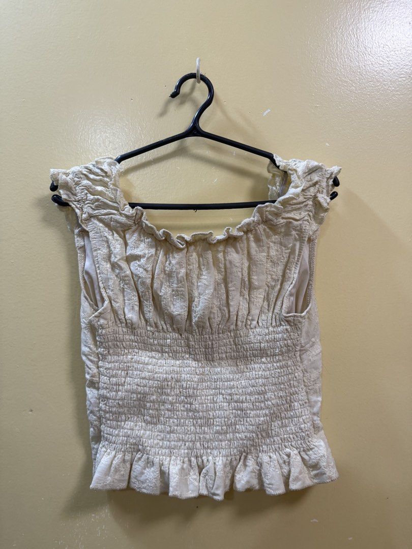 Yellow floral off-shoulder top (Category: Blouses) located in Makati City. Submitted by shoprory (Listing ID 1468594029, Image 2). Description: - Color/Pattern: Cream to yellow with all-over floral embroidery - Neckline: off-shoulder - Sleeves & Hem: Short ruffled cap sleeves with a matching ruffle hem - Fit: Stretchy full-smocking at the back for comfort and great fit.