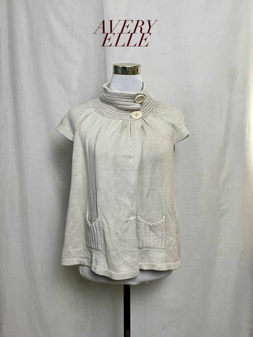 YOKED KNIT BUTTON TOP (Category: Sleeveless) located in Quezon City. Submitted by averyelleco (Listing ID 1468672421, Image 1). Description: - Brand: ELLE PLANETE - Color: Light grey - Design: Yoked knit top with short sleeves and ribbed turtleneck secured by two large buttons - Features: Soft chunky weave with functional front pockets - Condition: 7/10 layered condition, includes Japanese care label - Style Tip: Great layering piece for cooler w