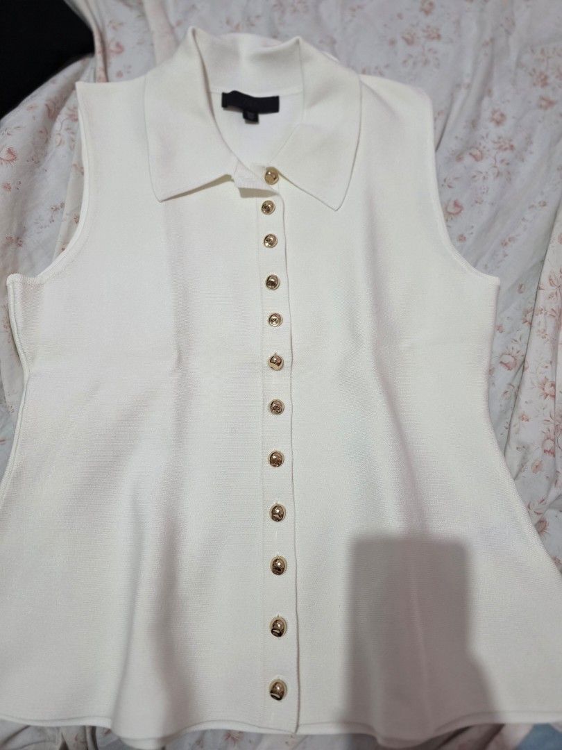 Zara (Category: Sleeveless) located in Caloocan City. Submitted by anjgeroni70315 (Listing ID 1468647959, Image 3). Description: - Brand: Zara - Style: Sleeveless knit top with collared neckline - Details: Gold-toned front buttons, soft ribbed texture - Size: Large (tag attached) - Condition: Brand new with original store tags.