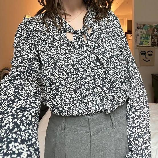 Zara Basic Black White Floral Pussy Bow Blouse (Category: Blouses) located in Binan City. Submitted by hannahbanana928 (Listing ID 1468710707, Image 1). Description: - Brand: Zara Basic - Design: Black with all-over white floral print - Features: Long sleeves, built-in tie neck/pussy bow detail - Material: Lightweight, comfortable, and easy to wear - Style: Buttonless slip-on - Versatility: Perfect for work or casual days out with jeans - Can fit
