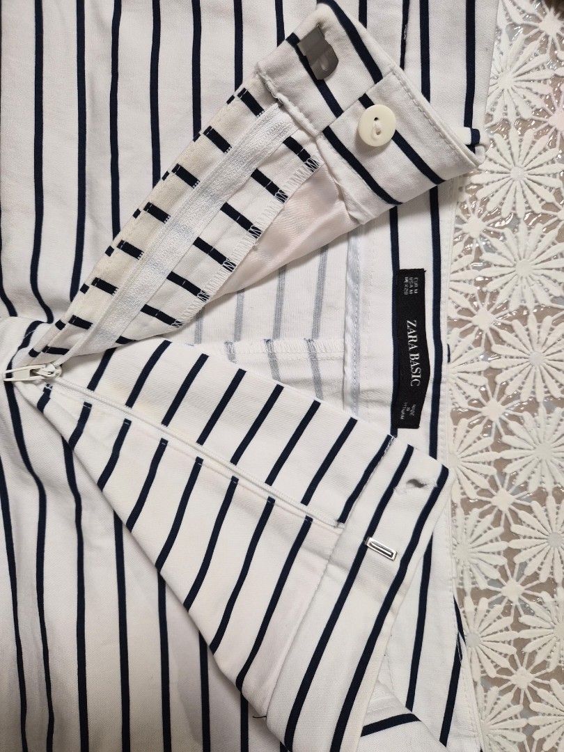 Zara Basic Navy and White Striped Shorts Size M (Category: Shorts) located in Manila. Submitted by prelovedbyc.hannah (Listing ID 1468588621, Image 3). Description: - Brand: Zara Basic - Item: Striped shorts - Color: Navy and white - Size: Medium (EUR M, USA M, MEX 28) - Design: Classic vertical stripes, front button & zipper closure, belt loops, and a buttoned back pocket - Origin: Made in Vietnam - Condition/Vibe: Great staple piece for warmer 