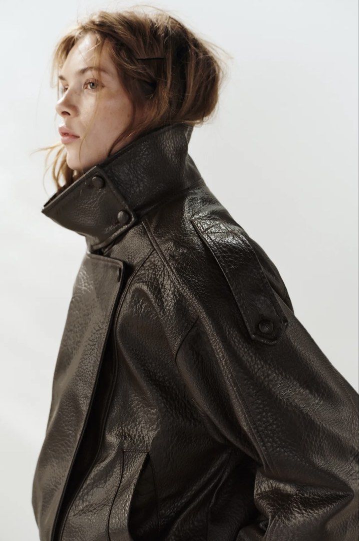 Zara Brown Leather Effect Biker Jacket (Category: Coats, Jackets and Outerwear) located in Makati City. Submitted by bibas.corner (Listing ID 1468546695, Image 2). Description: - Brand: Zara - Color: Dark Brown - Material: Faux Leather (textured) - Fit: Oversized - Features: High standing collar, shoulder button details, front pockets, elastic hem, and asymmetric front zip - Condition: Great layering piece for cooler weather.