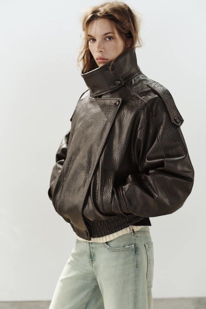 Zara Brown Leather Effect Biker Jacket (Category: Coats, Jackets and Outerwear) located in Makati City. Submitted by bibas.corner (Listing ID 1468546695, Image 1). Description: - Brand: Zara - Color: Dark Brown - Material: Faux Leather (textured) - Fit: Oversized - Features: High standing collar, shoulder button details, front pockets, elastic hem, and asymmetric front zip - Condition: Great layering piece for cooler weather.