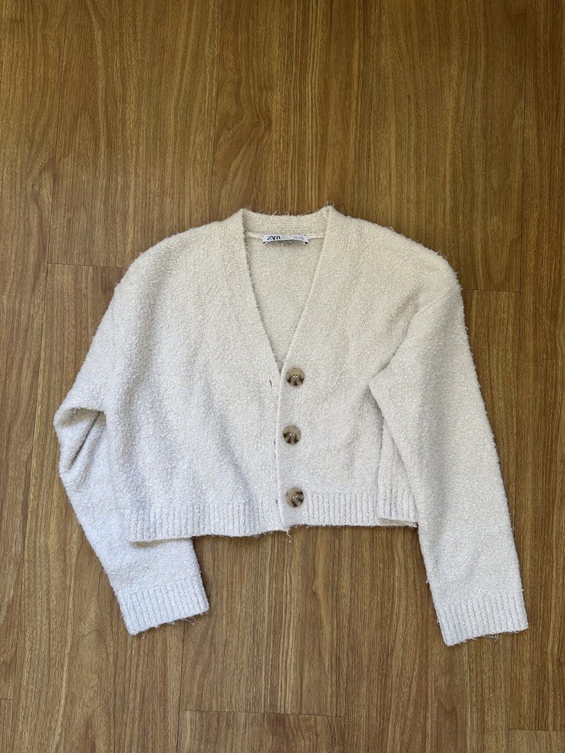 Zara Fluffy Cardigan in Cream (Category: Coats, Jackets and Outerwear) located in Mandaluyong City. Submitted by trishi.trish (Listing ID 1468568302, Image 1). Description: - Swipe to see when worn photos - In great condition - Material: Soft, fluffy fleece-like knit texture - Design: V-neck with 3 tortoiseshell-style front buttons, cropped fit, ribbed cuffs and hem - Original Price: 2395 I’m 5ft 3”, 32” bust and usually a size XS-S. Sizes when l