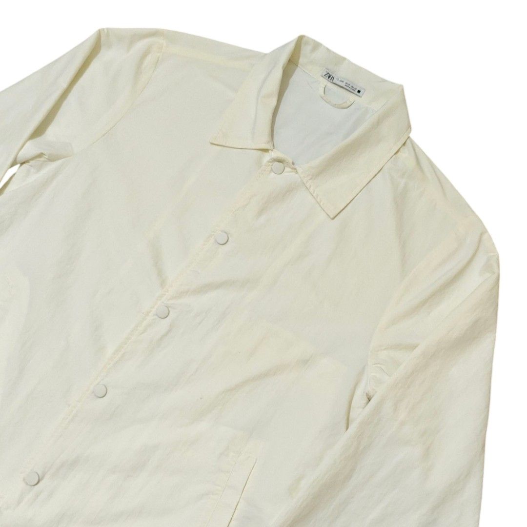 ZARA MAN Nylon Coach Jacket (Category: Coats, Jackets and Outerwear) located in Quezon City. Submitted by oldturnedtogold (Listing ID 1468600118, Image 3). Description: ZARA MAN Nylon Coach Jacket Size Medium White Shoulder Width - 19.5" Body length - 29" Chest Width - 22.25" Sleeve Length - 25.5" Details: - Nylon fabric - Lightweight and quick dry - Snap button closure - front welt pockets - adjuster on bottom hem - Shipping fee to be shouldered