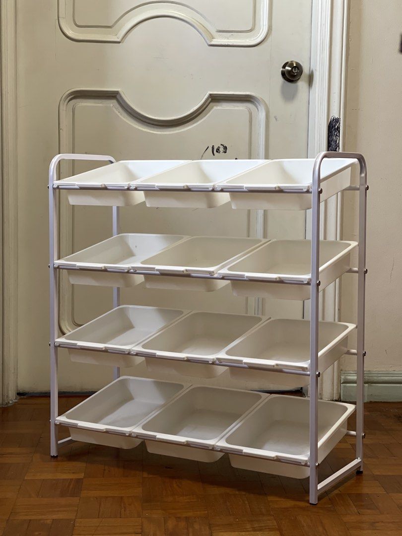 12 baskets 4-tier toy storage organizer with removable bins (Category: Storage Boxes & Baskets) located in Pasay City. Submitted by theclutterfree (Listing ID 1468715210, Image 1). Description: With wheels Width 70cm x 79cm Height x30cm Depth Sturdy white metal frame with 4 tiers - Includes 12 removable white plastic storage bins - Ideal for organizing toys, craft supplies, or small items - Equipped with 4 wheels for easy mobility around the room