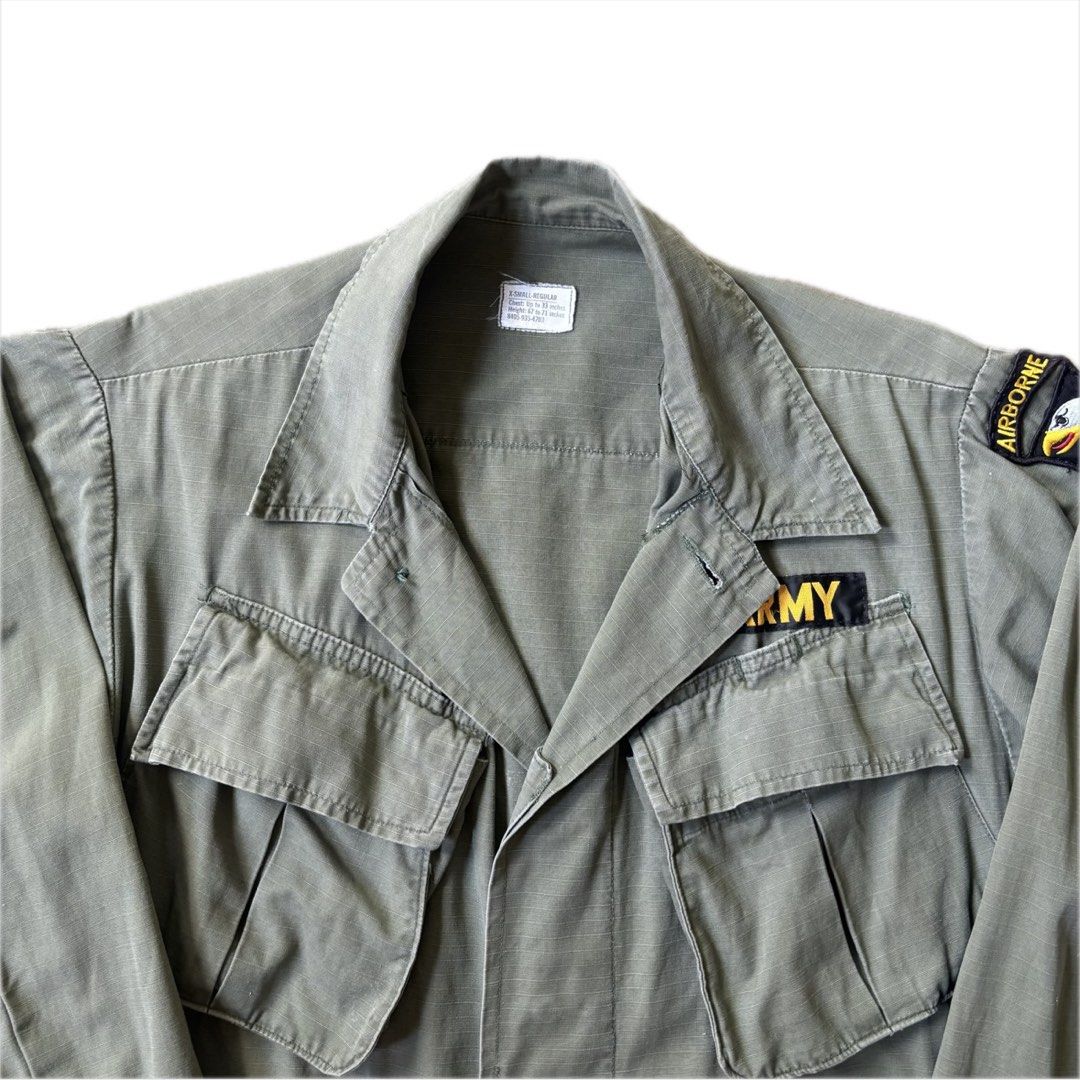 1970s US Army Jungle Fatigue Jacket (Extra Small Regular) (Category: Coats, Jackets and Outerwear) located in Manaoag. Submitted by mayonaise.store (Listing ID 1468796808, Image 2). Description: US Army 1970s 101st Airborne Jungle Jacket This is an authentic US Army 4th pattern tropical combat coat, commonly known as a jungle jacket, manufactured during the late Vietnam War era. First introduced in the mid-1960s to withstand tropical heat and moi