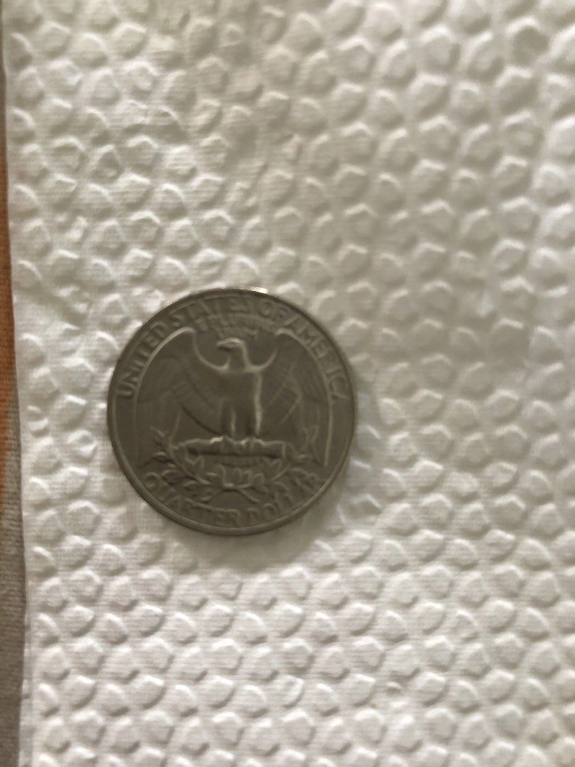 1985 US Washington Quarter Dollar Coin (Category: Currency) located in Muntinlupa City. Submitted by jkani (Listing ID 1468750154, Image 3). Description: - Item: 1985 United States Washington Quarter Dollar Coin - Obverse: Features the classic portrait of George Washington - Reverse: Detailed design of an eagle with outstretched wings - Material: Standard copper-nickel clad composition - Protection: Includes a clear protective coin capsule for sa