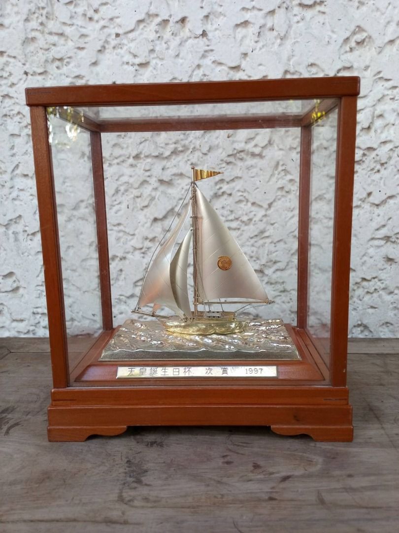 1997 Silver Sailboat Trophy/Figurine (Category: Vintage Collectibles) located in Caloocan City. Submitted by safetree_07089b (Listing ID 1468739230, Image 1). Description: - Vintage 1997 Emperor's Birthday Cup runner-up award miniature sailboat model - Encased in a clean, dust-free glass display with a sturdy wooden frame - Features detailed rigging, tiny masthead flag, and metallic finish on sails and hull - Beautiful textured wave base with an 
