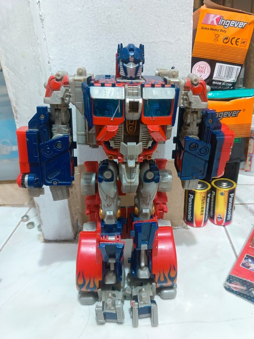 2pcs Transformers Optimus Prime Action Figure Robot Toy (Category: Action & Battle Toys) located in Manila. Submitted by mateochest99469 (Listing ID 1468910742, Image 1). Description: - Iconic Optimus Prime action figure in classic red, blue, and grey - Fully articulated joints for custom poses in robot mode - Detailed truck mode features on the legs and torso - Durable and solid plastic build - Perfect classic collector's piece for Transformers 