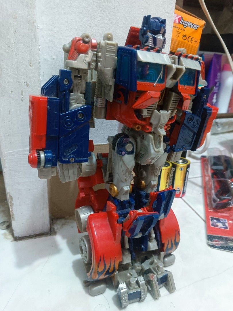 2pcs Transformers Optimus Prime Action Figure Robot Toy (Category: Action & Battle Toys) located in Manila. Submitted by mateochest99469 (Listing ID 1468910742, Image 2). Description: - Iconic Optimus Prime action figure in classic red, blue, and grey - Fully articulated joints for custom poses in robot mode - Detailed truck mode features on the legs and torso - Durable and solid plastic build - Perfect classic collector's piece for Transformers 