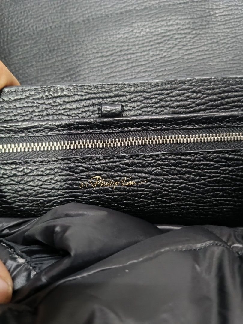 3.1 Phillip Lim Black Leather Shoulder Bag (Category: Luxury Bags & Wallets) located in Pateros City. Submitted by harry062182 (Listing ID 1468873154, Image 1). Description: - Brand: 3.1 Phillip Lim - Material: Black textured leather with silver-tone hardware - Authenticity: Serial number AC00-0179SKC stamped inside - Features: Structured top handle, adjustable shoulder strap, and stylish exterior zipper details - Interior: Clean lining with stam