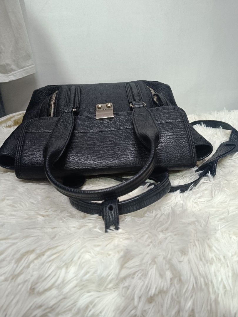 3.1 Phillip Lim Black Leather Shoulder Bag (Category: Luxury Bags & Wallets) located in Pateros City. Submitted by harry062182 (Listing ID 1468873154, Image 3). Description: - Brand: 3.1 Phillip Lim - Material: Black textured leather with silver-tone hardware - Authenticity: Serial number AC00-0179SKC stamped inside - Features: Structured top handle, adjustable shoulder strap, and stylish exterior zipper details - Interior: Clean lining with stam
