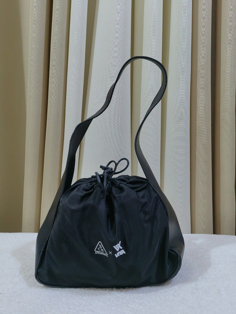3CE x Viya Black Drawstring Shoulder/kili Bag (Category: Shoulder Bags) located in Makati City. Submitted by prelovedtreatedwithlove (Listing ID 1468886986, Image 2). Description: - Brand: 3CE x Viya collaboration - Color: Classic Black with white printed logos - Material: Soft nylon body with sturdy leather - Interior: Roomy and spacious for all your daily essentials - Condition: Excellent/Clean look - Style: Versatile, minimalist design that go