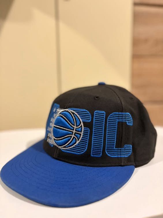 '47 Brand Orlando Magic NBA Snapback Hat (Category: Caps & Hats) located in Cebu City. Submitted by ubecstoned (Listing ID 1468824858, Image 2). Description: - Brand: '47 Brand x Mitchell & Ness Hardwood Classics - Team: Orlando Magic - Color: Black crown with royal blue flat brim - Design: Large raised embroidered team wordmark and basketball graphic on front - Fit: Adjustable snapback closure - Condition: Clean shape with high-quality embroider