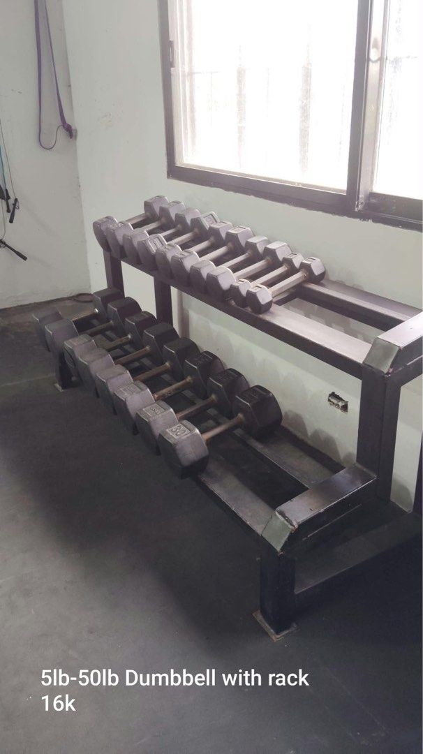 5lb-50lb Hex Dumbbell Set with Heavy Duty Rack (Category: Weights & Dumbbells) located in Pasig City. Submitted by rhi-stock (Listing ID 1468777801, Image 1). Description: - Complete set: Rubber hex dumbbells ranging from 5lb to 50lb - Includes a sturdy, two-tier black metal storage rack - Ergonomic handles featuring a firm knurled grip - Condition: Normal wear and tear on metal and rubber surfaces from regular gym use - Ideal and durable setup f