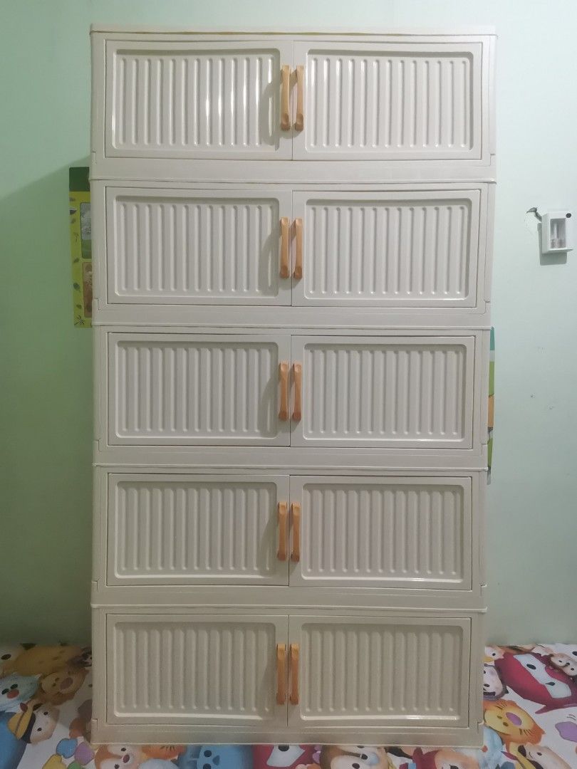5-Tier Plastic Storage Cabinet Organizer White (Category: Shelves, Cabinets & Racks) located in Valenzuela. Submitted by nafie330 (Listing ID 1468836971, Image 2). Description: - 5-level white plastic storage cabinet with double-door compartments - Chic cream-off-white shade with vibrant orange handles - Dimensions: 141cm (H) x 80cm (W) x 29cm (D) - High capacity for clothes, toys, or general household clutter - Clean inside and out, all doors an