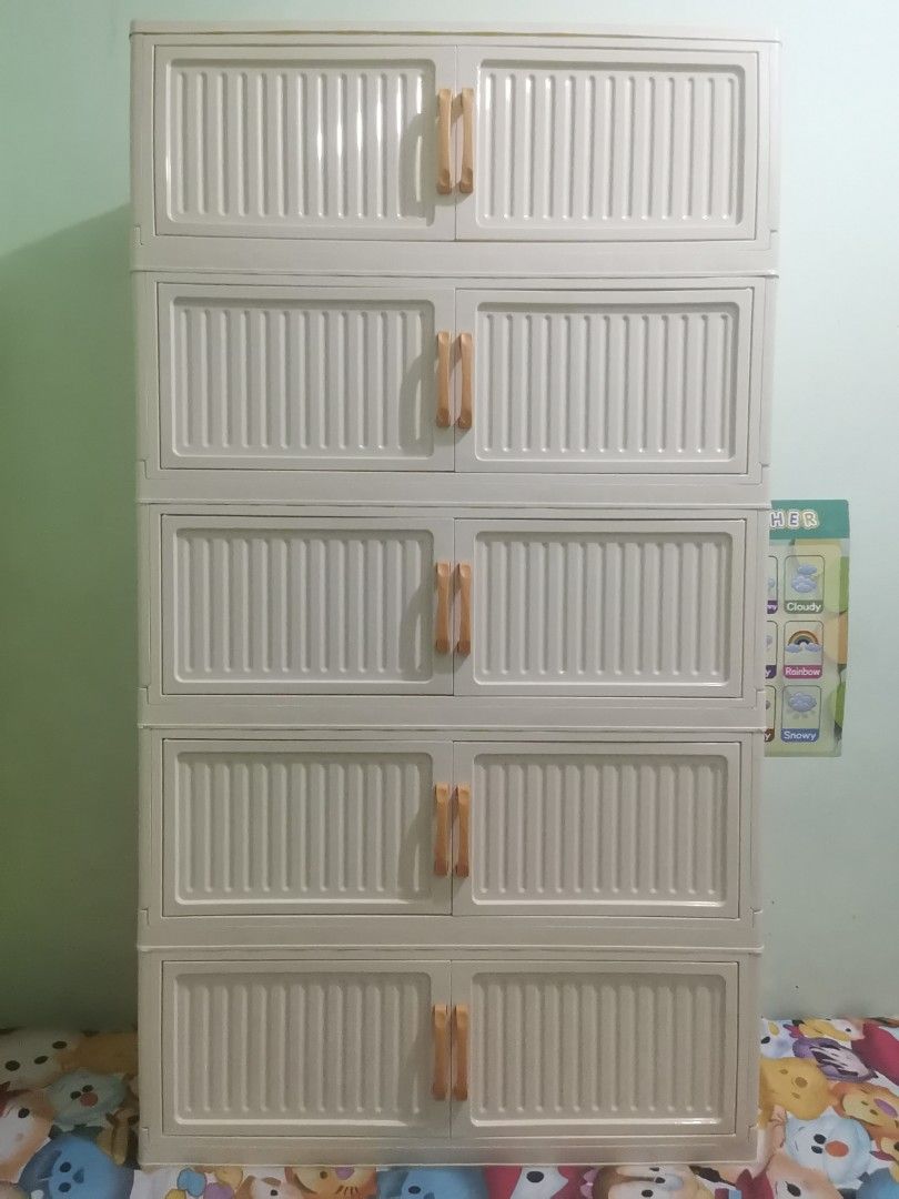5-Tier Plastic Storage Cabinet Organizer White (Category: Shelves, Cabinets & Racks) located in Valenzuela. Submitted by nafie330 (Listing ID 1468836971, Image 3). Description: - 5-level white plastic storage cabinet with double-door compartments - Chic cream-off-white shade with vibrant orange handles - Dimensions: 141cm (H) x 80cm (W) x 29cm (D) - High capacity for clothes, toys, or general household clutter - Clean inside and out, all doors an